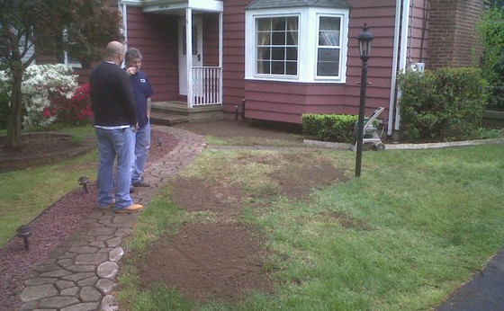 Foreman and homeowner with regraded work area