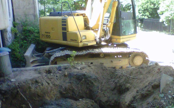 Contaminated grave with full size excavator