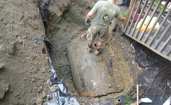 Tank next to house fully uncovered