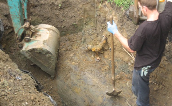 Uncovering a buried tank directly next to the house with a Mini Excavator