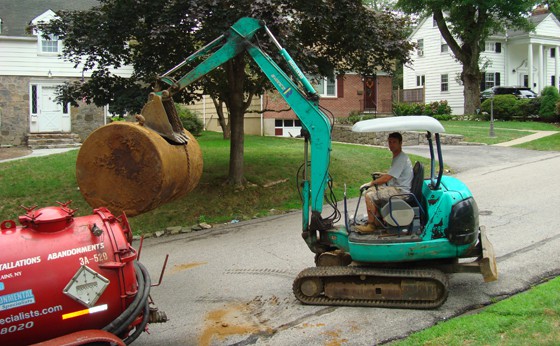 Zach brings tank to be loaded on to trailor for proper disposal